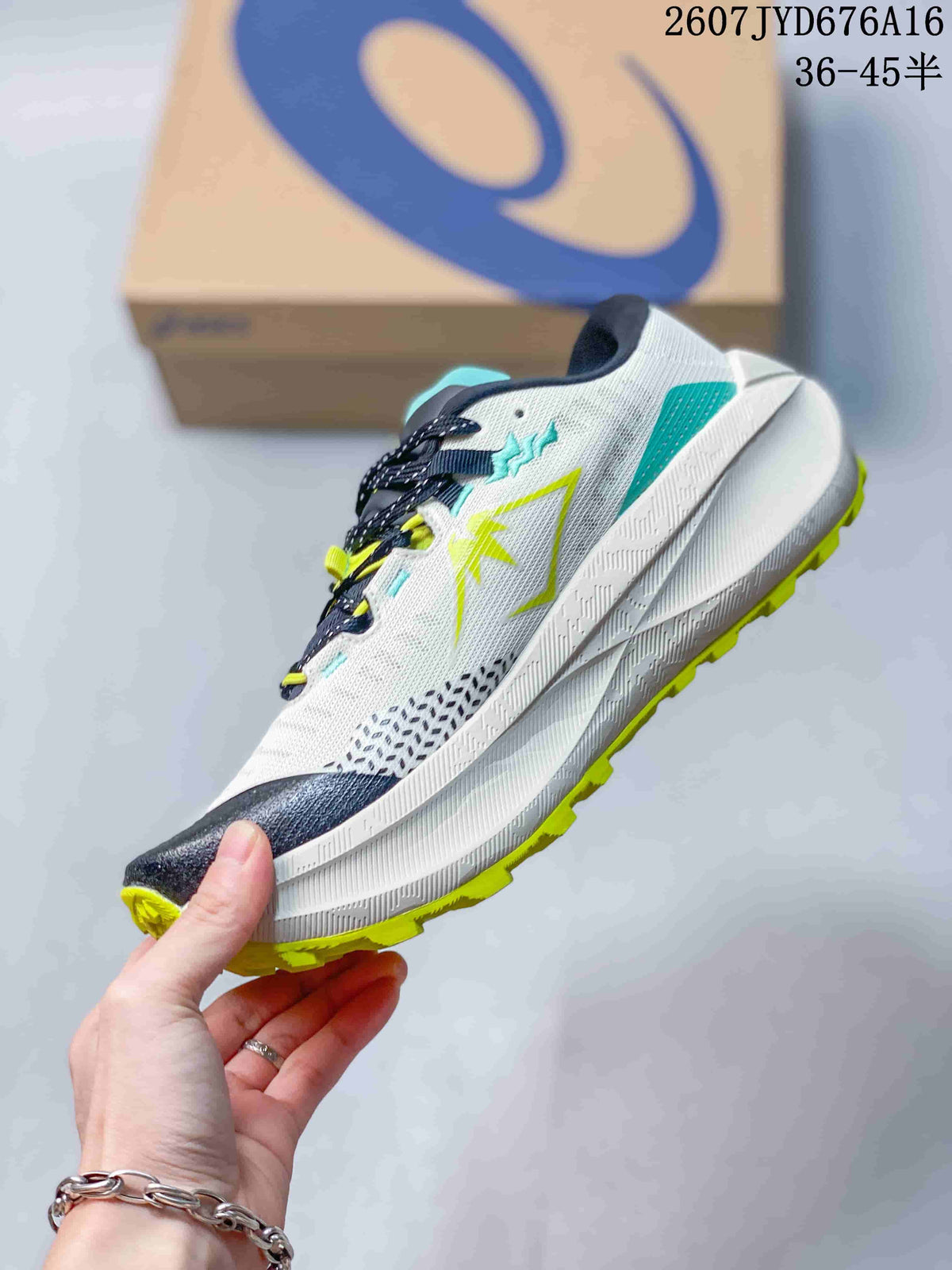 Side view of the white ASICS trail running shoe with lime and turquoise overlays, dark toe detailing, and a layered white midsole.