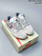 Pair of pale gray and white low-top sneakers with patterned gray laces and contrast swooshes on a shoebox.