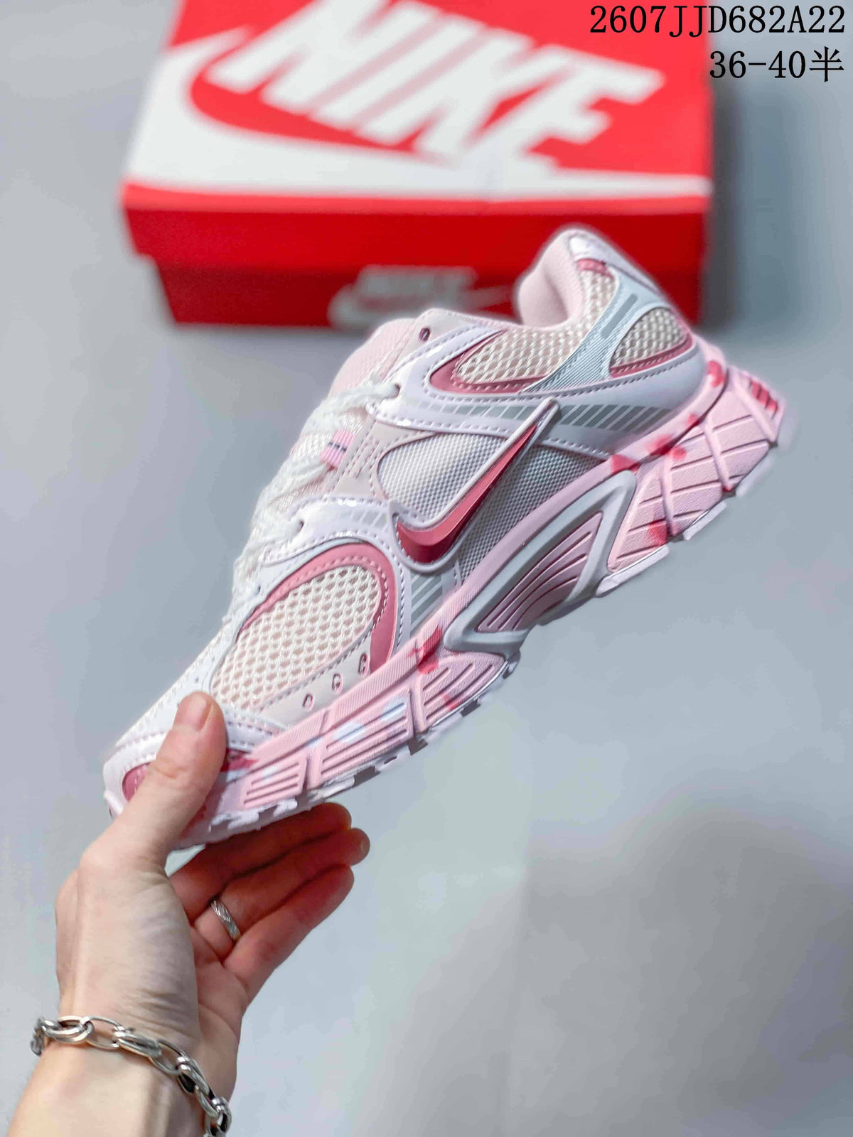 Side view highlighting the layered upper, mesh panels, contrast swoosh details, and sculpted sole.
