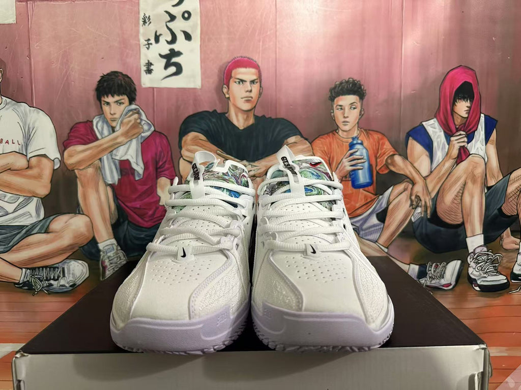 Front view of white Nike basketball sneakers with perforated toe panels, white laces and multicolor tongue details.