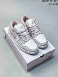 White and pale pink Jordan 1 Low sneakers shown from the front on a shoe box.