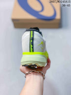 Rear view of the white sneaker showing the heel structure, neon yellow trim, and contrasting center stripe.