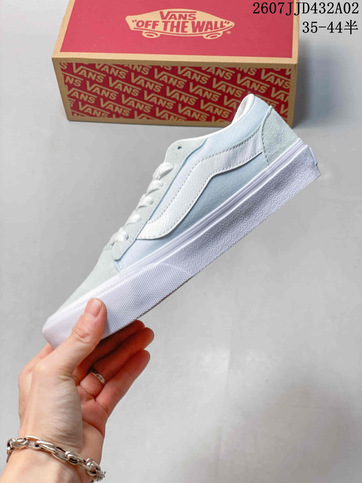 Side profile of the pale blue and white low-top sneaker with a white side stripe.