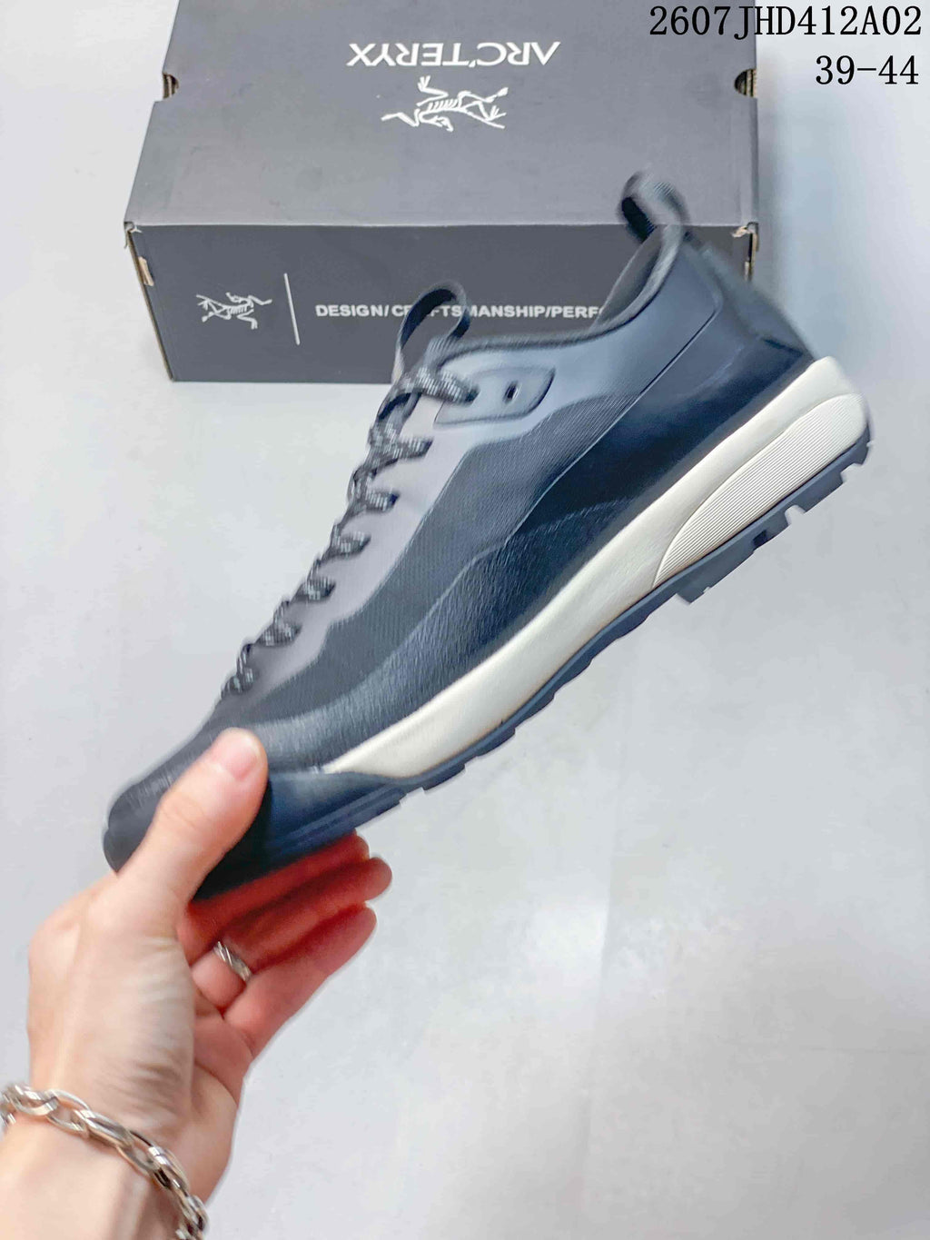 Side profile of the gray lace-up shoe with a light-colored midsole