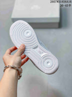 Close view of the white outsole showing concentric circular tread details, textured edges, and an AIR marking.