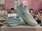 Angled view of the light gray Nike basketball shoes with colorful lace accents and sculpted soles