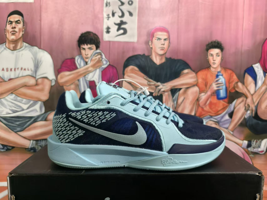 Side view of a blue and black Nike Kobe basketball shoe with a light blue Swoosh