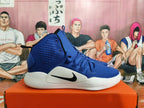 Side view of a blue Nike Hyperdunk shoe with a black Swoosh and white midsole