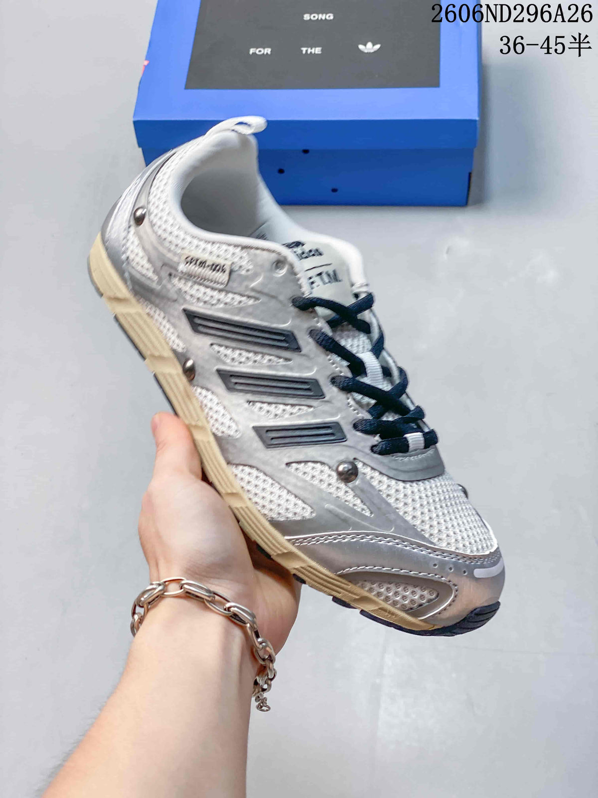 Silver and white Adidas SFTM-006 low-top sneaker with dark laces and a cream-colored outsole.