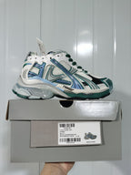 Side view of the Balenciaga Runner sneaker above its box, with the box label showing Runner, White/Emerald Green, code 0623, and size 37.