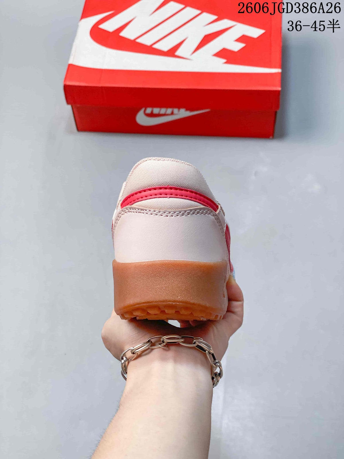 Rear view of the sneaker showing the pale pink heel, red accent strip and gum-colored outsole.