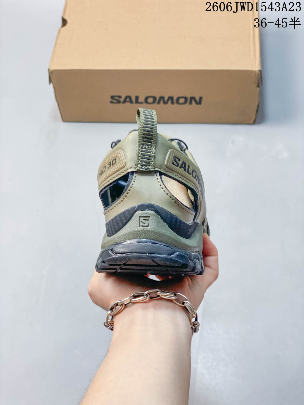 Rear view of the olive-toned shoe showing the heel structure and pull tab