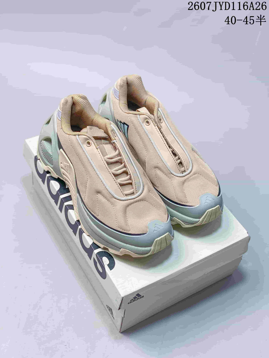 Pair of beige and pale mint adidas low-top sneakers displayed on an adidas shoe box, with the product code and size range overlaid at the top.