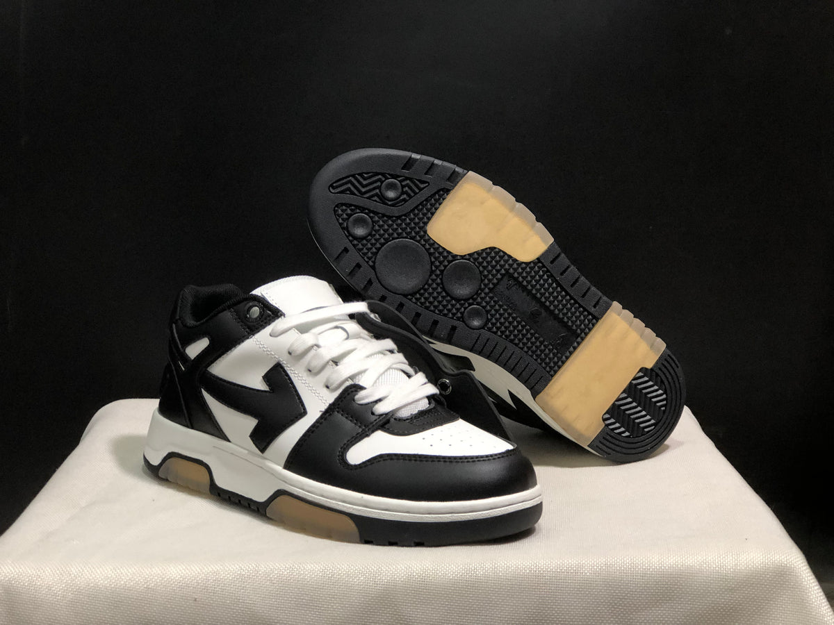Angled view of the sneakers with one shoe lifted to show the black outsole and translucent traction sections.