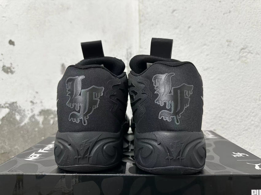 Rear view of black high-top basketball shoes with tonal heel graphics and sculpted soles.