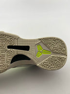 Close-up of the patterned outsole and neon yellow logo detail