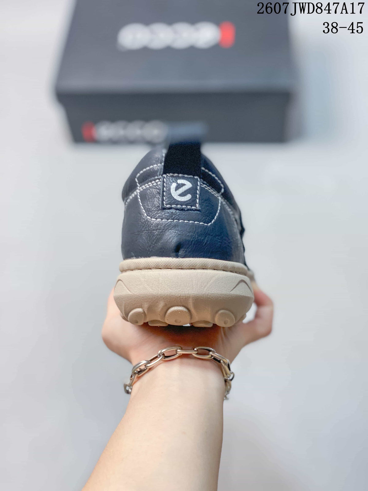 Rear view of the navy slip-on shoe showing the heel pull tab, contrast stitching, and textured outsole.