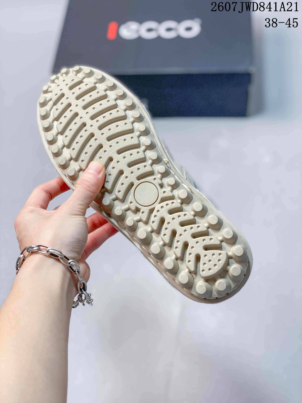 Close-up of the sneaker outsole showing raised circular and segmented tread elements.