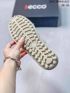 Close-up of the sneaker outsole showing raised circular and segmented tread elements.