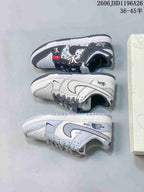 Three low-top sneaker colorways shown from above: gray patterned, white patterned, and pale gray with branded graphics.