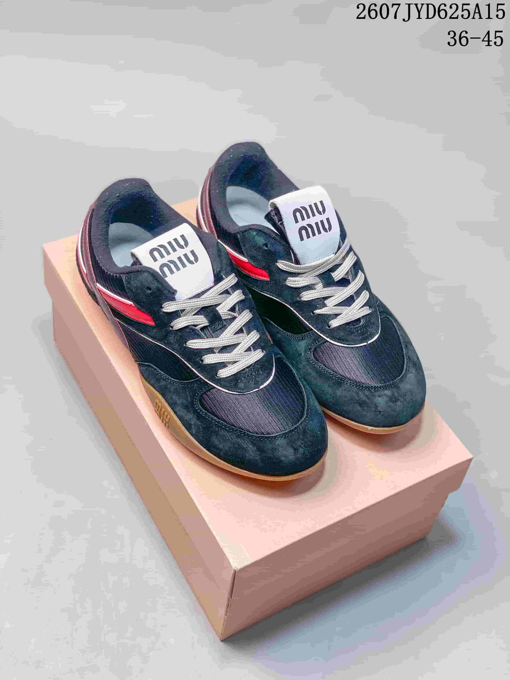 Pair of black low-top sneakers with red accents, white laces, gum outsoles and a box; image text shows style code 2607JYD625A15 and size range 36–45.