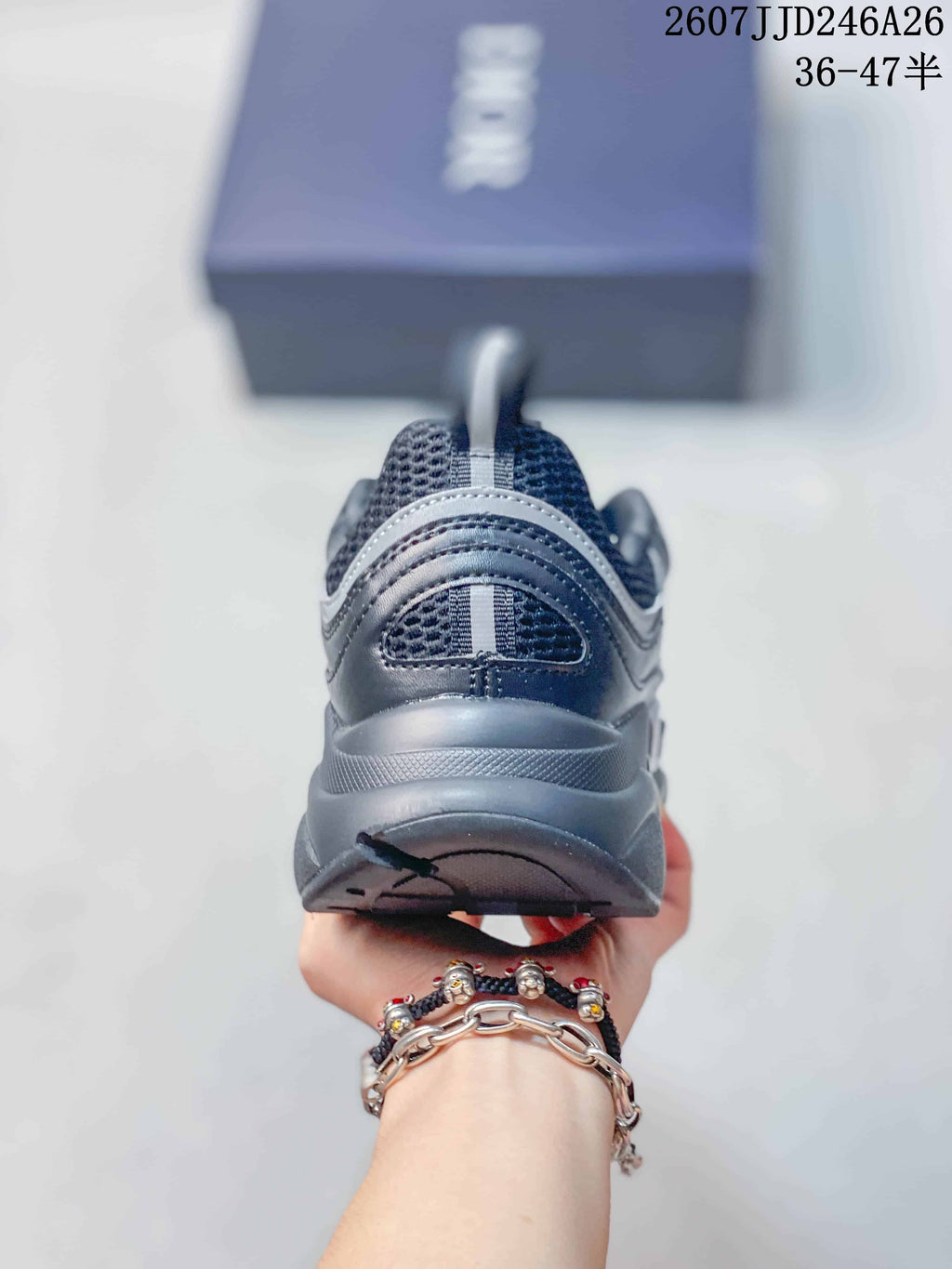 Rear view of the dark gray sneaker showing the padded collar, heel pull tab, and chunky outsole.