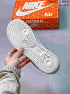 Underside of a white Air Force 1 sneaker showing circular outsole tread