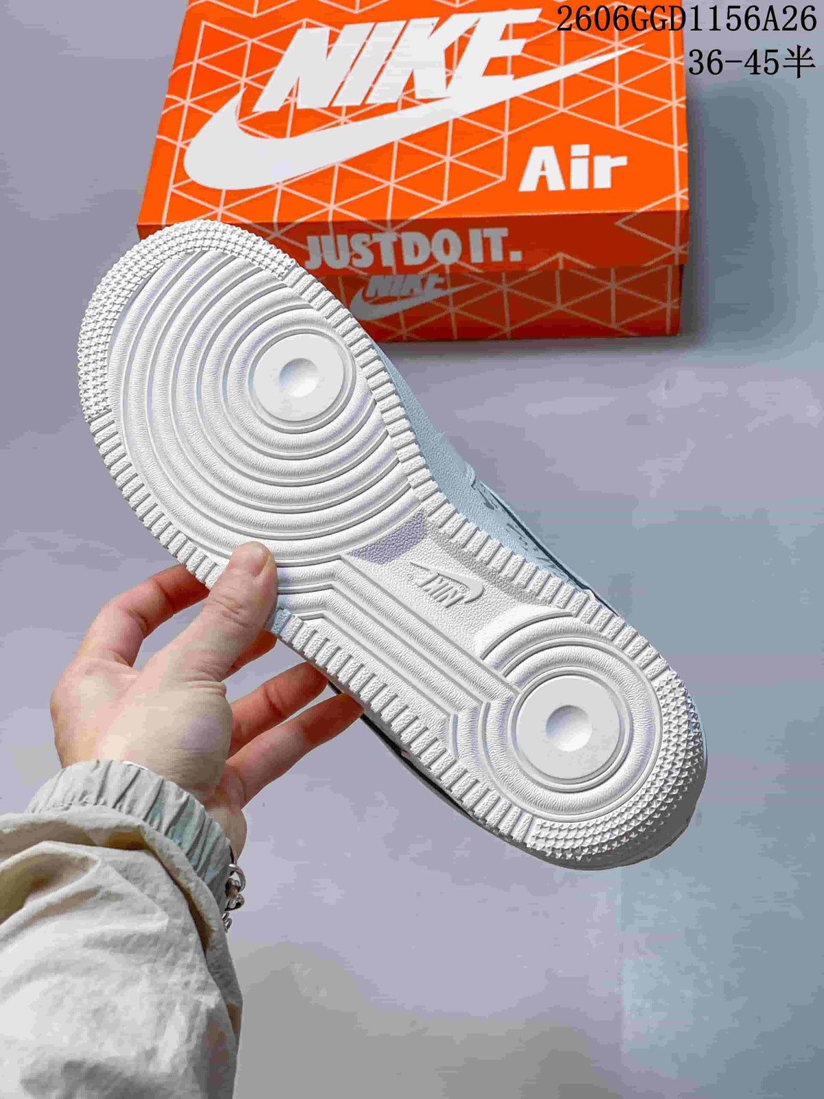 Underside of a white Air Force 1 sneaker showing circular outsole tread