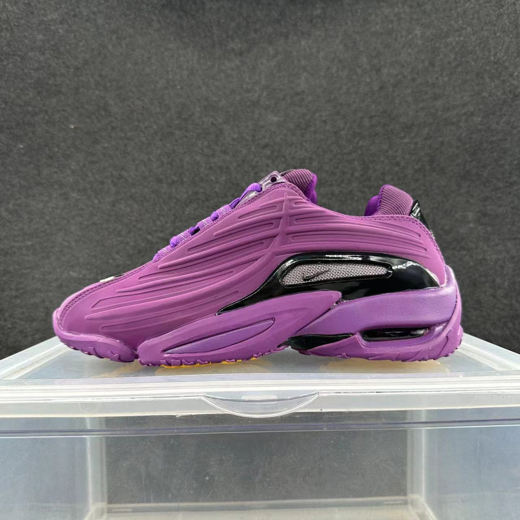 Purple low-top sneaker shown from the side with a glossy dark accent