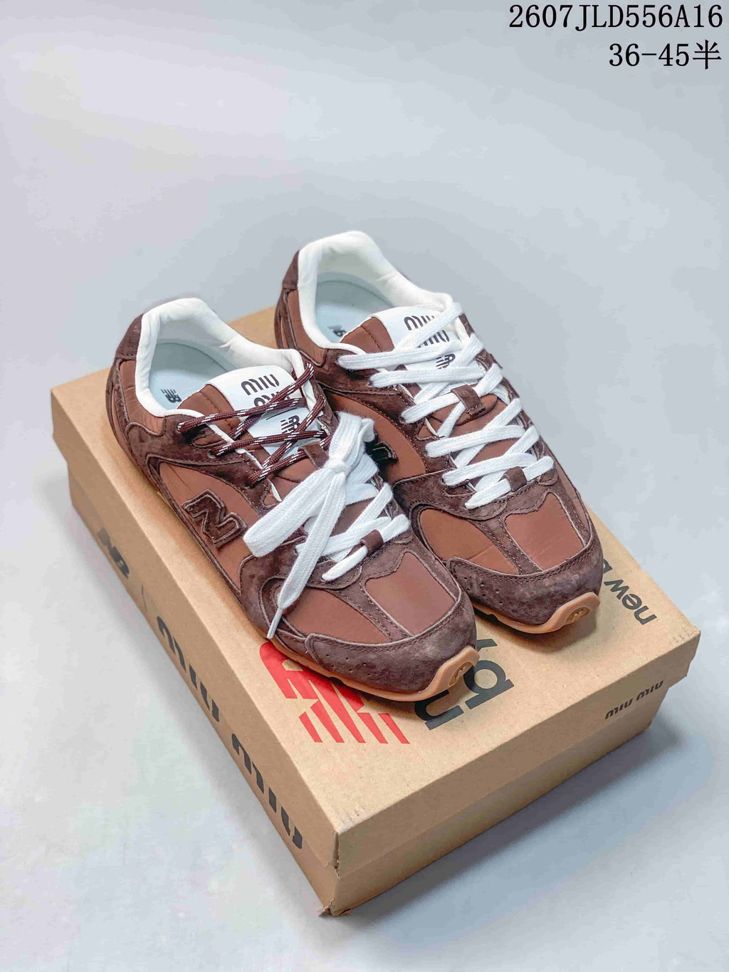 Green and brown sneakers shown together on branded boxes, highlighting the contrasting colorways and layered upper design.