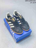 Pair of dark adidas Originals Samba sneakers with white stripes and gum-colored soles