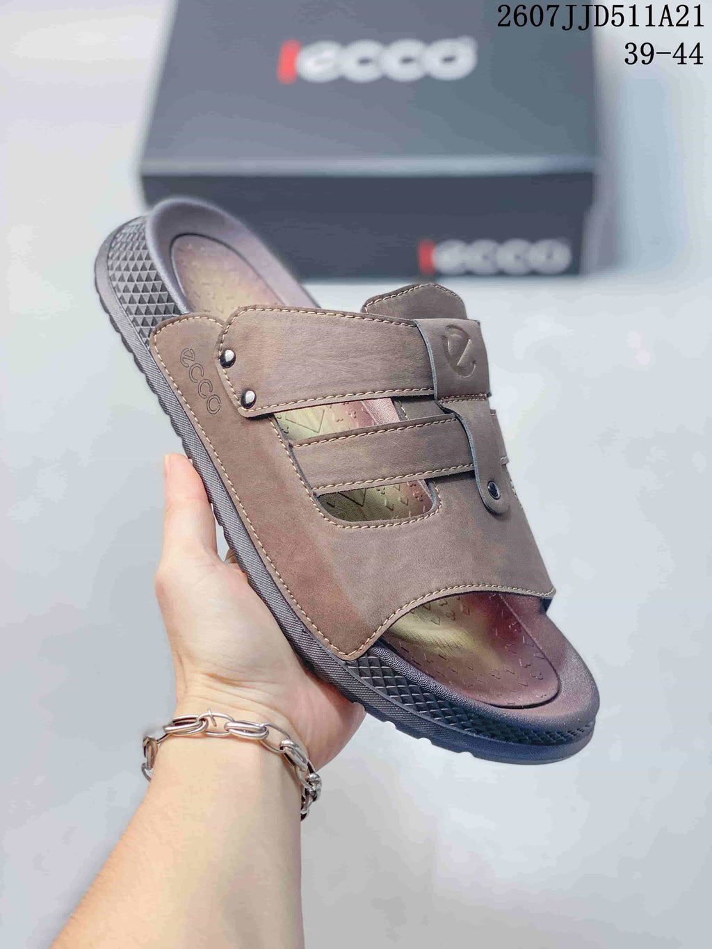 Angled close-up of the brown sandal showing the ECCO branding, layered straps, open toe, and textured outsole.