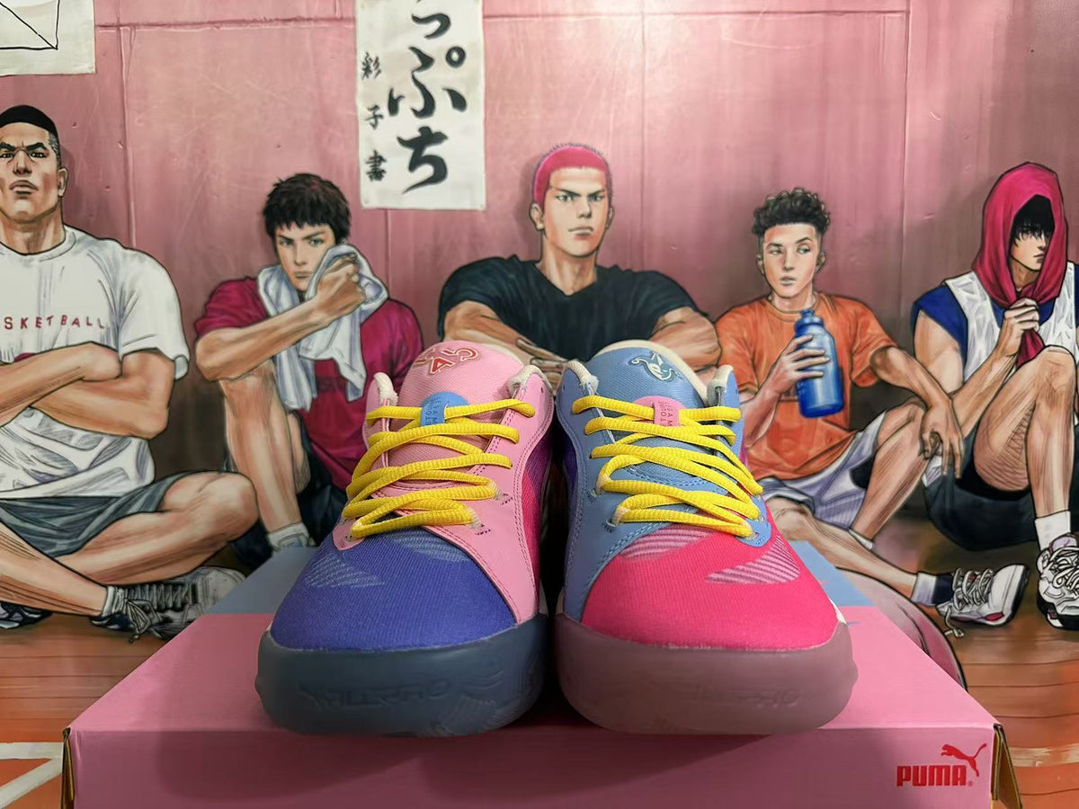 Front view of mismatched pink and blue PUMA basketball shoes with yellow laces.