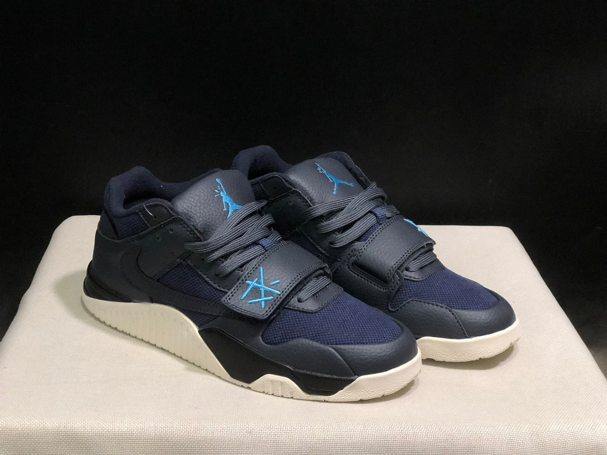 Three-quarter view of the dark black and navy sneaker pair with blue details and cream outsoles.