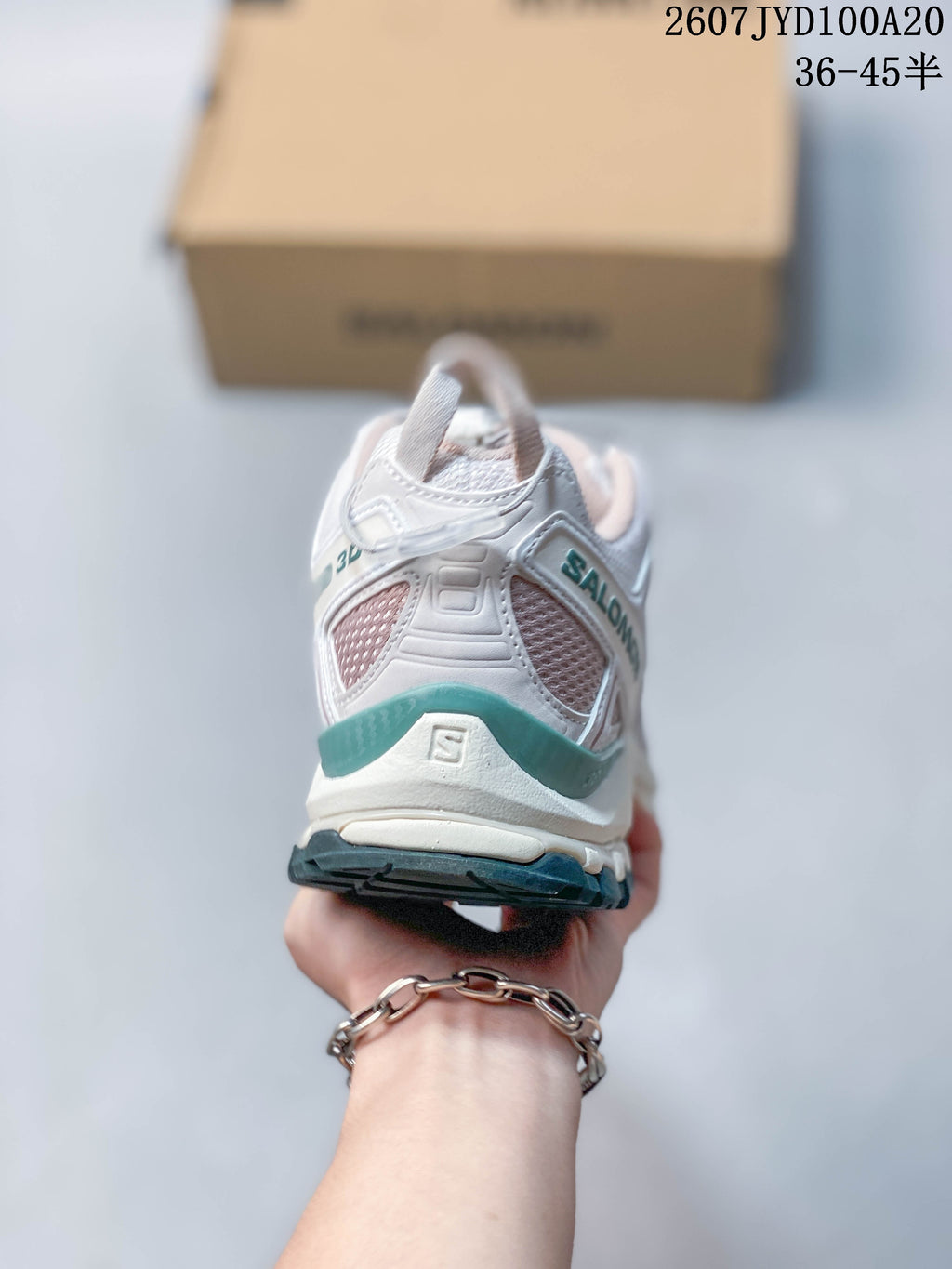 Rear view of the white Salomon XA PRO 3D sneaker showing heel overlays, mesh panels and teal trim.