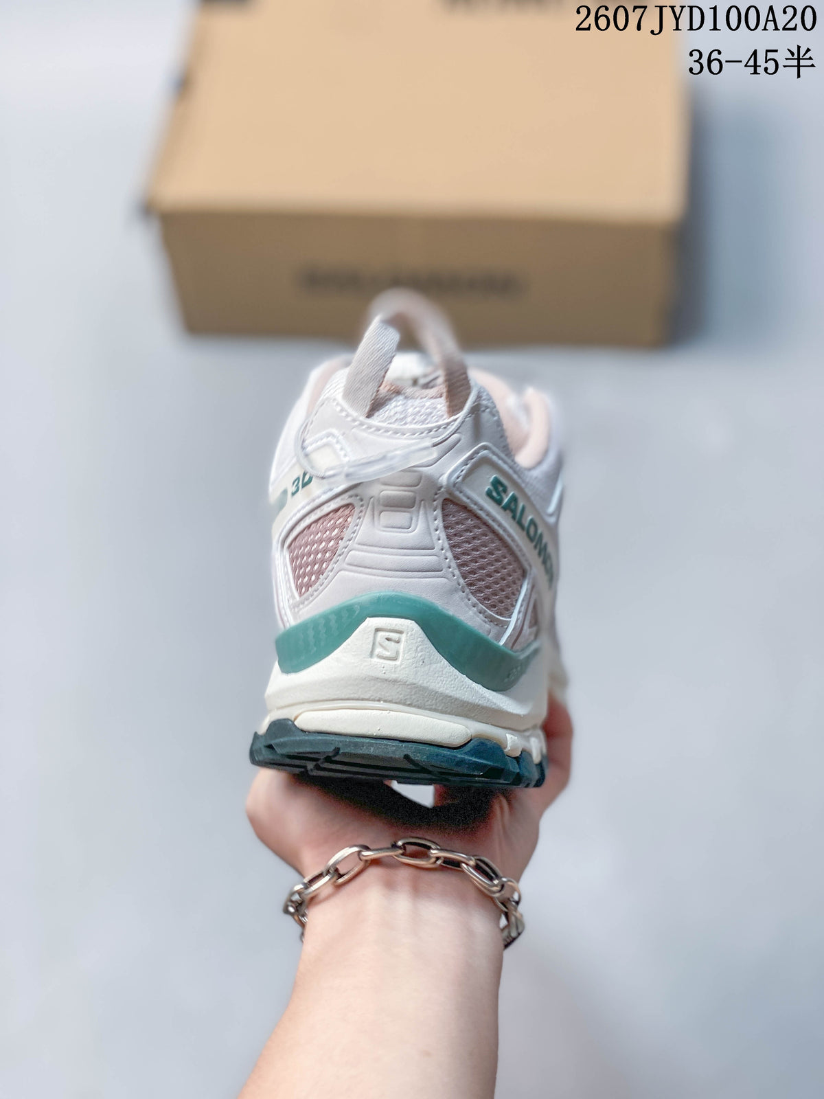 Rear view of the white Salomon XA PRO 3D sneaker showing heel overlays, mesh panels and teal trim.