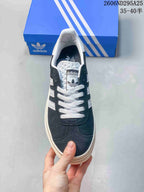 Top view showing the white laces, tongue label, dark navy upper, and white padded collar.
