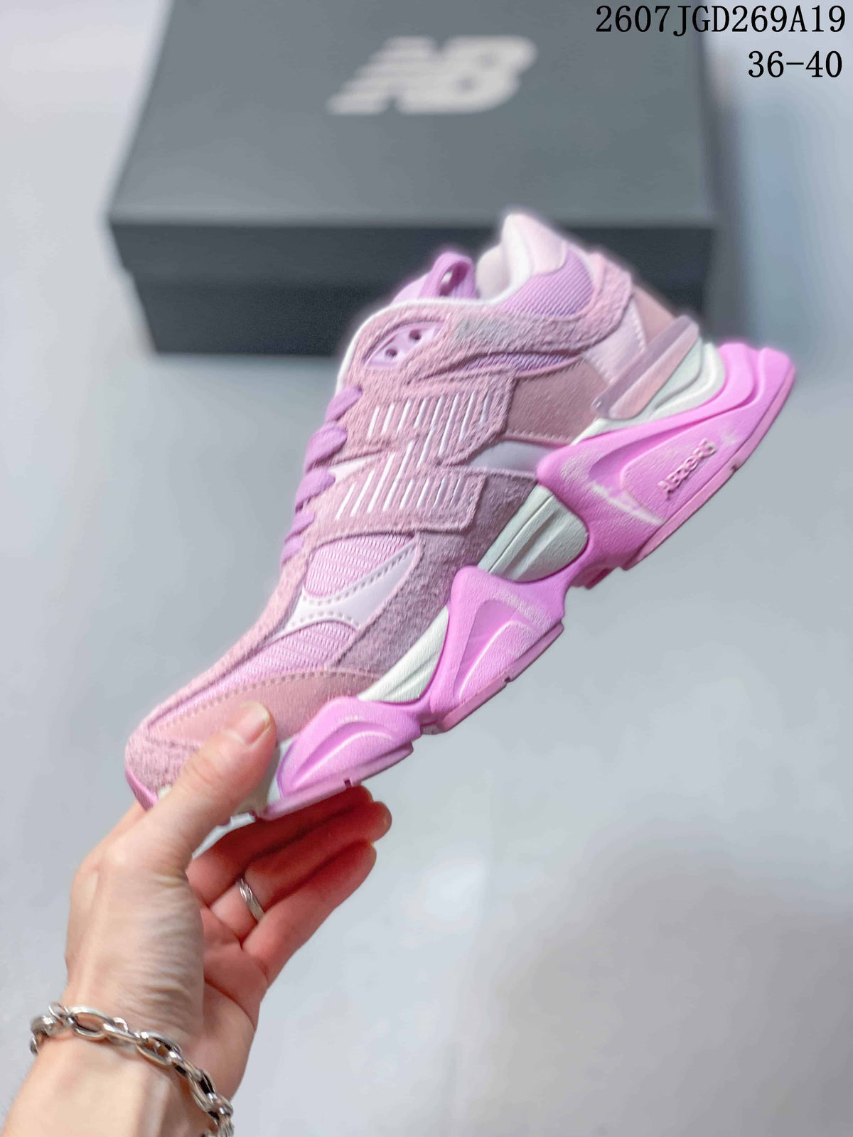 Side profile showing the layered upper, large New Balance logo, mesh sections, and sculpted platform-style sole.