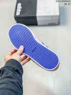 Blue rubber outsole of the sneaker showing a repeating circular tread pattern and Adidas logo.