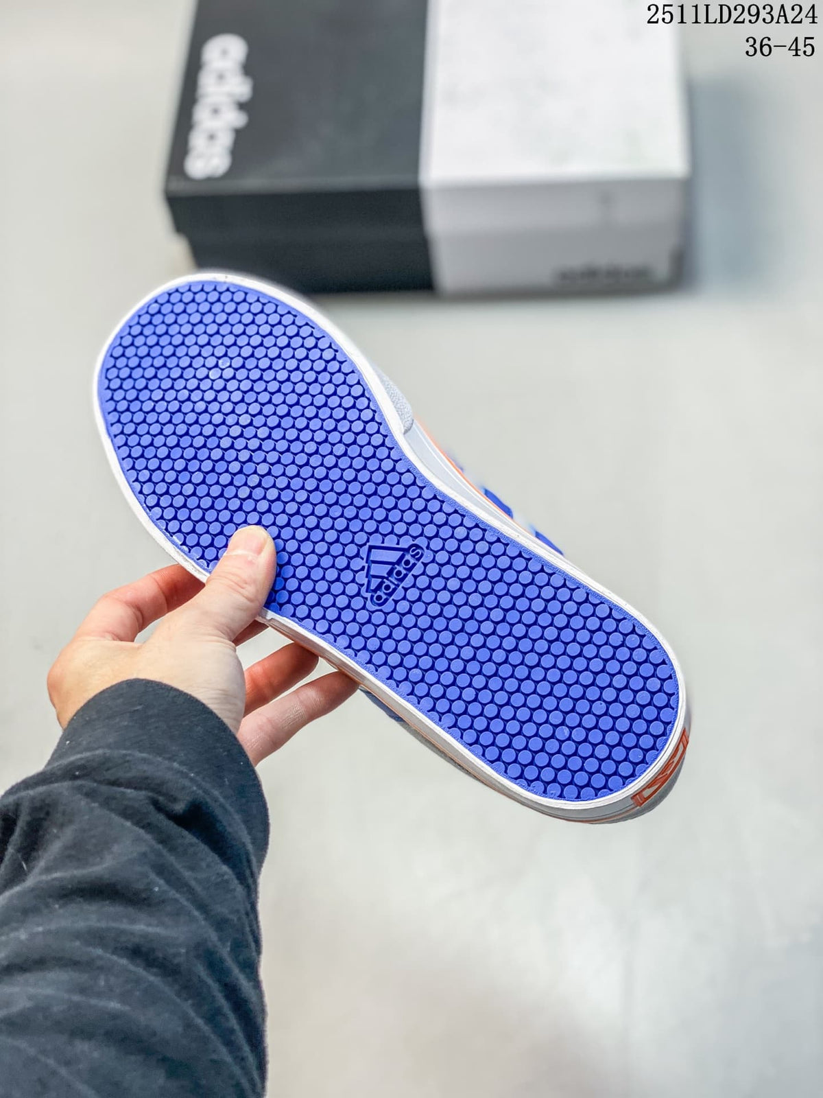 Blue rubber outsole of the sneaker showing a repeating circular tread pattern and Adidas logo.