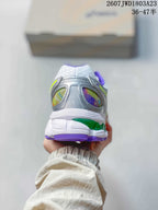Rear view of an ASICS sneaker showing the padded heel, silver panels, multicolor inserts, and purple outsole edge.