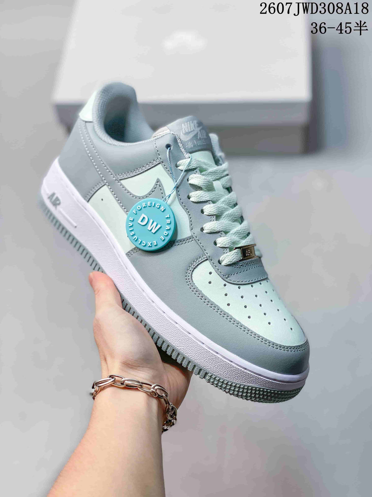 Angled side view showing the low-top sneaker shape, pale blue panels, white midsole and visible Nike branding.