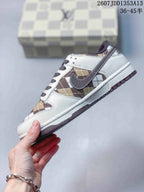 Side profile showing the white upper, brown plaid panels, dark swoosh, and layered sole.
