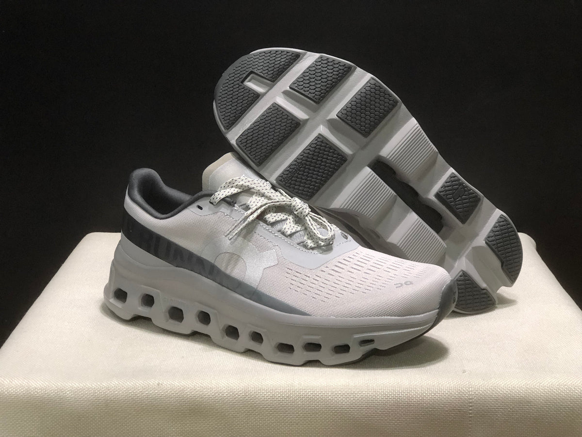 Angled view showing one shoe above the other with the textured outsole and geometric tread sections visible.