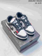 Gray and white low-top sneakers with patterned side panels, dark overlays, and patterned laces on a printed box.