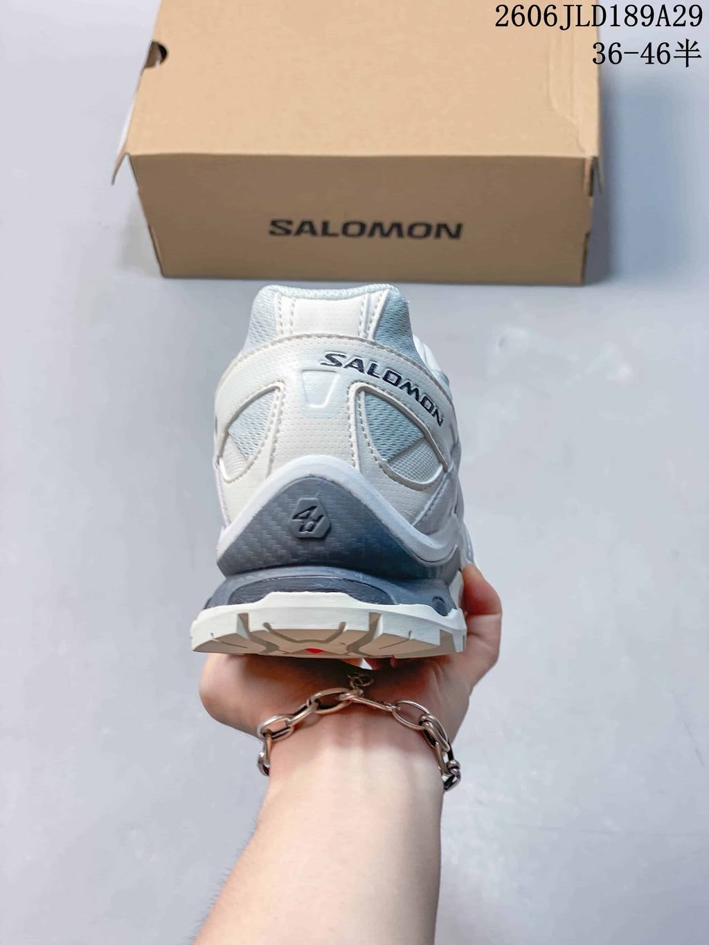Rear view of a white and gray Salomon XT-Quest ATHR sneaker.