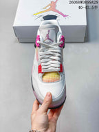 Front view of the sneaker showing white laces, pink supports, and a multicolor gradient panel.