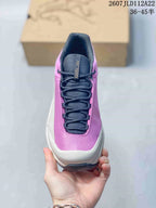 Top view of the shoe showing dark laces, a padded tongue and pink textured upper.
