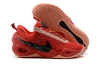 Red Nike Anthony basketball shoes with peach-colored soles, shown from the side and sole.