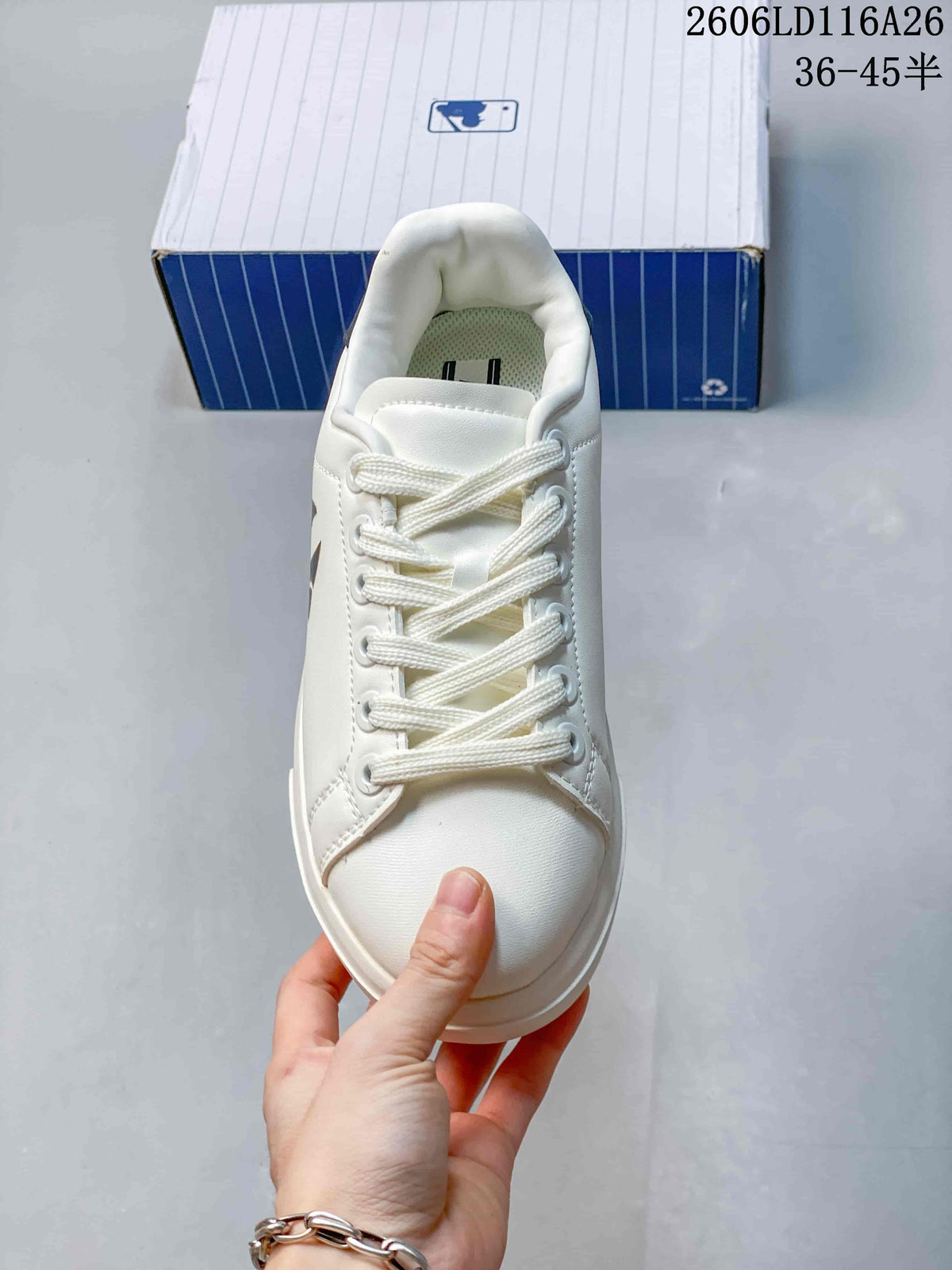 Top view of the white lace-up sneaker showing the padded tongue, rounded toe, and stitched panels.